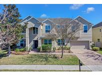 Stunning two-story home with mature trees, brick driveway, and lush landscaping at 4951 Cypress Hammock Dr, St Cloud, FL 34771