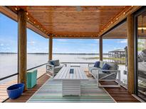Relaxing waterfront dock featuring cozy seating and a beautiful view at 17648 Live Oak Dr, Tavares, FL 32778