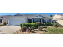 Charming single-story home with well-maintained landscaping and an attached two-car garage at 2304 Jonesbury Run, The Villages, FL 32162