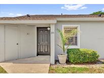 Exterior view of unit 311 featuring a stylish black front door and manicured landscaping at 311 Dorchester Sq, Lake Mary, FL 32746