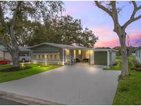 Charming single-story home featuring a covered carport and spacious driveway at 511 Bonita Dr, Lady Lake, FL 32159