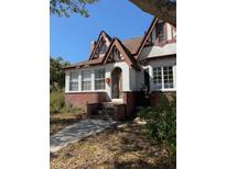 Charming Tudor-style home featuring brick accents, gabled roof, and inviting front entrance at 1326 East Ave, Clermont, FL 34711