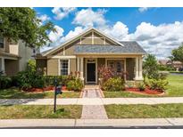 Charming single-story home with a manicured front yard and covered porch at 303 White Water Bay Dr, Groveland, FL 34736