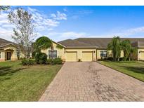 Charming townhome with a brick driveway, attached garage, and well-maintained landscaping at 3206 Sonesta Ct # A, Clermont, FL 34711