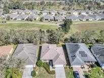 Bird's eye view of single-Gathering home with a manicured lawn and a view of the community golf course at 4331 Arlington Ridge Blvd, Leesburg, FL 34748