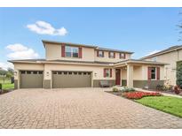 Charming two-story home with a three-car garage and a beautifully landscaped front yard at 11579 Acosta Ave, Orlando, FL 32836