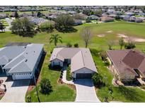 Beautiful aerial view of home with mature landscaping, a large lawn, and a neatly designed driveway at 12199 Se 175Th Loop, Summerfield, FL 34491