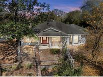 Charming single-story home featuring a landscaped front yard and cozy front porch at 25013 Adair Ave, Sorrento, FL 32776