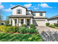 Charming two-story home featuring a well-manicured lawn and a welcoming front porch at 2505 Civitas Pl, Casselberry, FL 32707