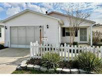 Charming single-story home with white picket fence and well-maintained landscaping at 2910 Barboza Dr, The Villages, FL 32162
