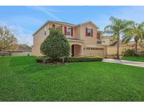 A beautiful two story home with a well-manicured lawn, lush landscaping and inviting curb appeal at 30342 Gidran Ter, Mount Dora, FL 32757