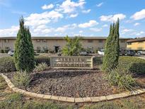 Lakeview Condominium community sign with beautiful landscaping and manicured greenery at 1100 E Caroline St # 218, Tavares, FL 32778