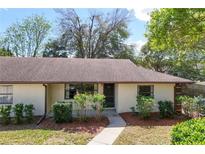 Charming single-story home with a well-maintained lawn and mature trees at 12418 Clubhouse Ct, Tavares, FL 32778