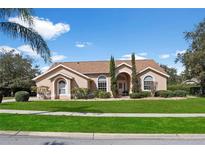 Charming single-story home with a well-manicured lawn and landscaped front yard, offering great curb appeal at 12626 Douglas Fir Ct, Clermont, FL 34711