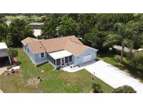 Charming blue single-story home with well-manicured lawn and attached one car garage at 1416 Lindsey Ln, The Villages, FL 32159