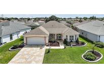 Charming single-story home with a well-manicured lawn and a stone driveway at 2114 Gerardo Ave, The Villages, FL 32159