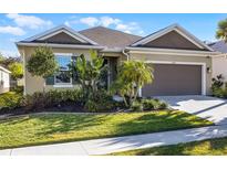 Charming single-story home featuring a well-manicured lawn and a two-car garage at 3009 High Pointe St, Clermont, FL 34711