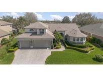 Beautifully landscaped home featuring a three-car garage and inviting curb appeal at 4256 Fawn Meadows Cir, Clermont, FL 34711