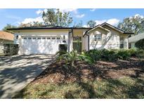Charming single-story home with a two-car garage and well-maintained landscaping in a sunny neighborhood at 6035 Falconbridge Pl, Mount Dora, FL 32757