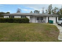 Charming single story home with a spacious front yard and a well-maintained landscape at 713 Lillian Cir, Eustis, FL 32726