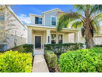 Charming two-story home with a covered front porch and meticulously landscaped yard at 11090 Silver Surfer Aly, Winter Garden, FL 34787