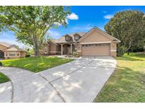 Stunning single-Gathering home features a well-manicured lawn and a spacious two-car garage at 17408 Tailfeather Ct, Clermont, FL 34711