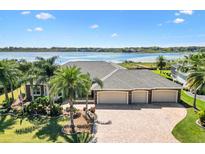 Stunning waterfront home with three-car garage, lush landscaping, and views of the lake at 2332 Clearwater Run, The Villages, FL 32162