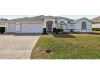 Charming single-story home with a well-manicured lawn and an attached two-car garage at 5332 Nw 20Th Pl, Ocala, FL 34482