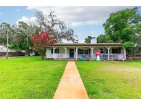 Charming single-story home featuring a well-manicured lawn and a quaint front porch at 132 E Belt Ave, Bushnell, FL 33513