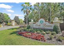 Loch Leven Mount Dora community entrance sign with landscaped flowers and plants on a sunny day at 2031 Capri Ln, Mount Dora, FL 32757