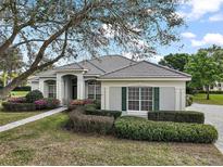 Charming single-story home with a well-manicured lawn and colorful flower beds at 2031 Capri Ln, Mount Dora, FL 32757