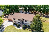 Expansive two-story home featuring a charming brick facade and lush landscaping at 16017 Harbar Oaks Dr, Montverde, FL 34756