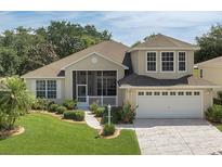Charming home featuring a well-manicured lawn and inviting front porch at 6122 Sailboat Ave, Tavares, FL 32778