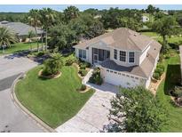 Beautiful two-story home with attached two-car garage and manicured lawn and landscaping at 6122 Sailboat Ave, Tavares, FL 32778