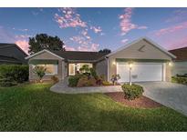 Charming single-story home with well-manicured lawn, landscaped garden, and inviting curb appeal at 776 Alcott Ave, The Villages, FL 32162