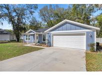 Charming single-story home with a well-manicured lawn, a two-car garage, and attractive curb appeal at 804 Deep Wood Ct, Fruitland Park, FL 34731