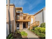 Charming townhome with a private balcony, lush landscaping, and inviting walkway, perfect for relaxing outdoors at 1051 S Highland St # 7E, Mount Dora, FL 32757