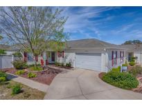 Charming home with a well-maintained lawn, driveway, and an attached two-car garage at 17714 Se 84Th Sheldon Ter, The Villages, FL 32162