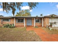 Charming single story home with brick exterior, covered entryway, and mature landscaping at 33311 Green Rd, Leesburg, FL 34788