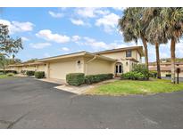 Inviting home exterior featuring a well-manicured lawn and a private two-car garage at 100 S Tremain St # G1, Mount Dora, FL 32757