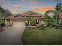 Well-maintained home exterior with mature landscaping and a three-car garage at 1239 Russell Loop, The Villages, FL 32162