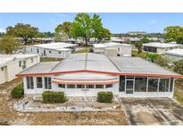 Charming single-story home featuring a screened-in lanai and well-maintained landscaping at 1312 Apache Cir, Tavares, FL 32778
