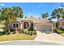 Charming one-story home featuring a lush lawn, mature landscaping and an attached two-car garage at 1797 Pamplico Ct, The Villages, FL 32162