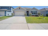 Charming single-story home featuring a well-manicured lawn, neutral paint, and an attached two-car garage at 3719 Holly Grove Ln, Mount Dora, FL 32757