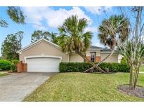 Charming single-story home with a well-manicured lawn and a two-car garage at 39905 Bayview Dr, Lady Lake, FL 32159