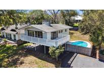 Charming two-story home featuring a wraparound balcony and a refreshing pool at 603 N Lakeshore Blvd, Howey In The Hills, FL 34737