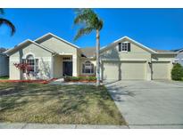 Charming single-story home featuring a three-car garage, palm tree, and beautifully manicured lawn at 1851 Soaring Heights Cir, Orlando, FL 32837