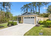 Charming home featuring a two-car garage, well-maintained lawn, and beautiful landscaping at 3441 Possehl Pl, The Villages, FL 32163