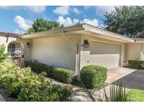 Charming home featuring a one-car garage and a beautifully landscaped front yard at 100 S Tremain St # C2, Mount Dora, FL 32757