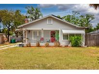 Charming single-story home featuring a front porch, gray siding, and a well-manicured lawn at 1515 Washington Ave, Eustis, FL 32726
